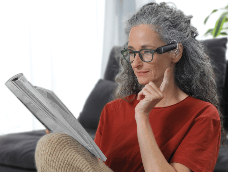 Woman reading using the OrCam MyEye