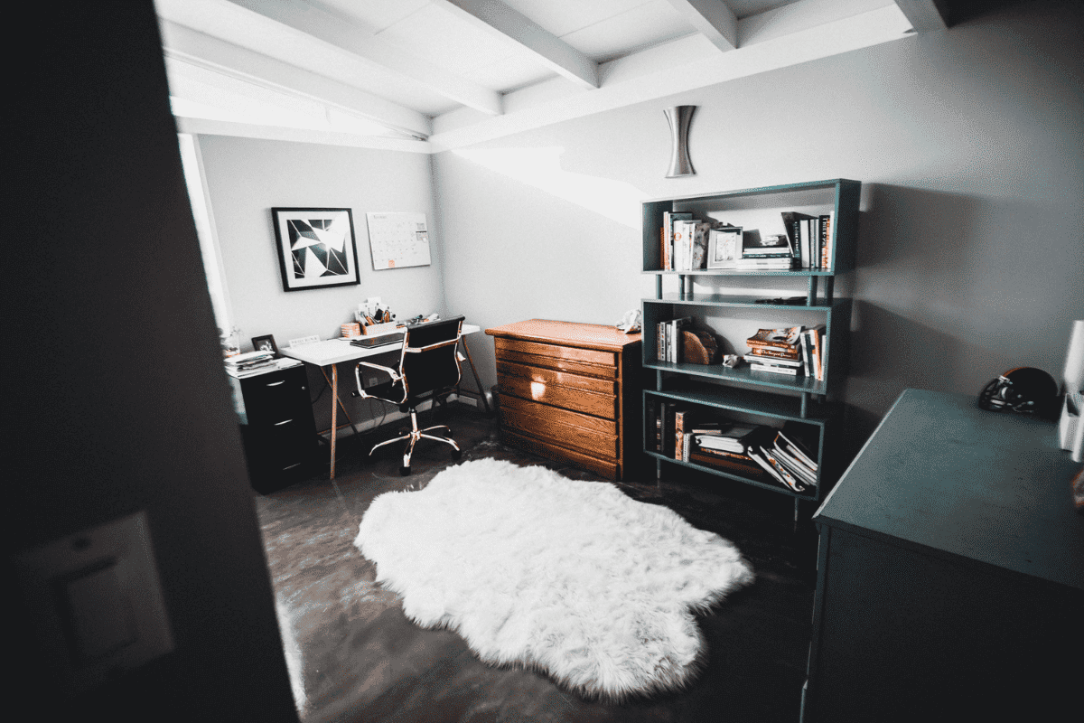 White area rug on dark wood floor.