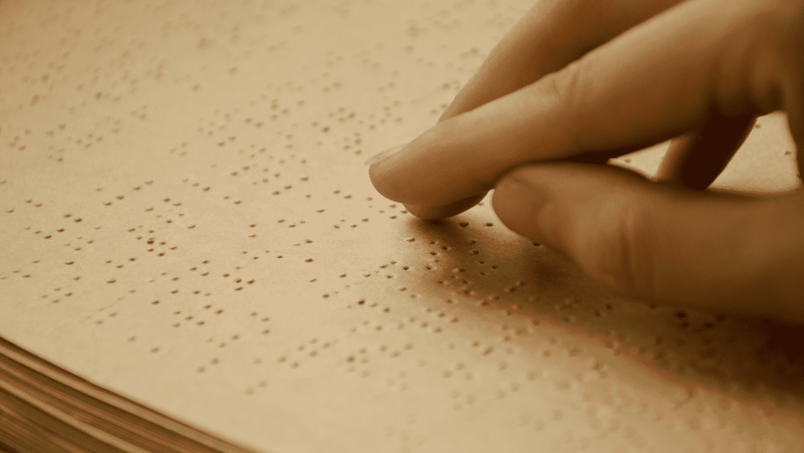 Person reading a braille book