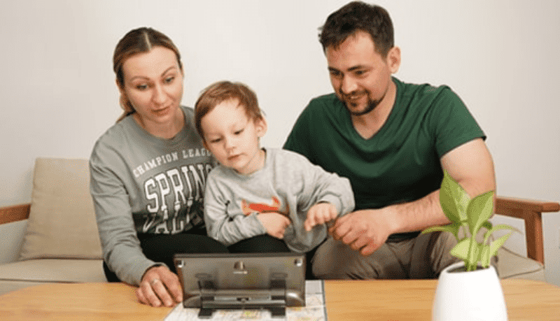 Family trying out Luna 8 video magnifier