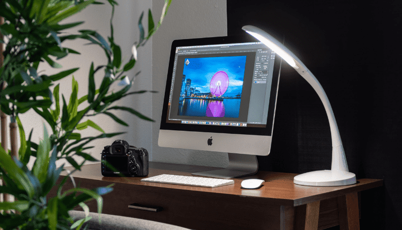 Stella GO portable LED lamp with computer on desk