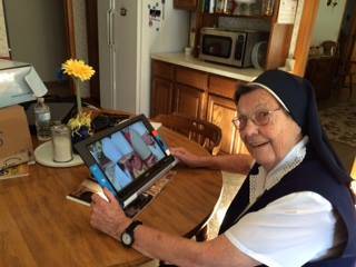 Sister Pauline Sauvageau of Berlin, NH with a Traveller HD video magnifier