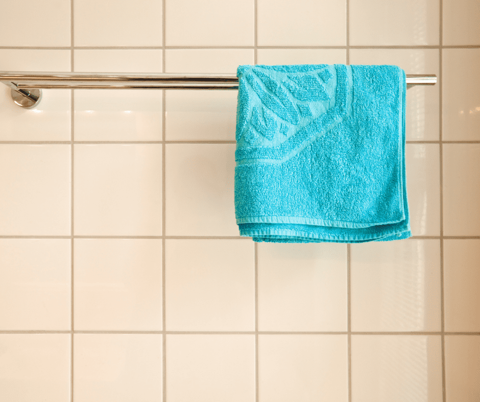 Blue bath mat against light colored tile