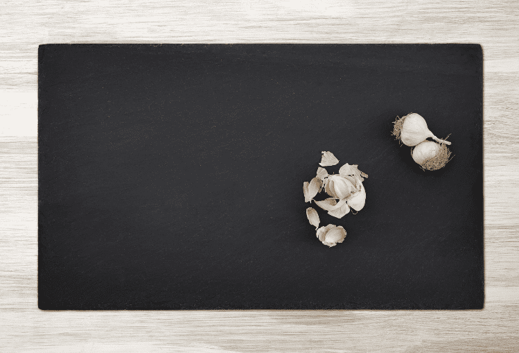 Garlic on black cutting board