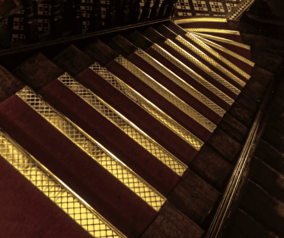 Yellow safety lines on dark staircase for color contrast and low vision