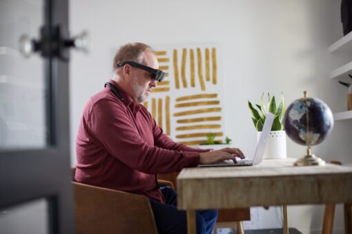 Person working at computer wearing eSight