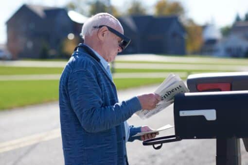 Person checking mail wearing eSight