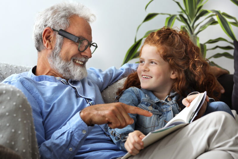 Adult using OrCam to read with child