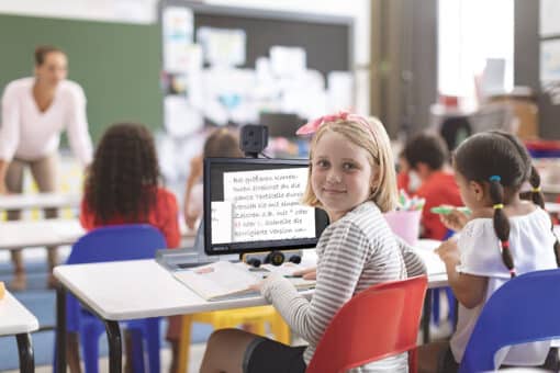 Student in classroom using video magnifier