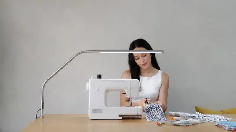 Daylight Slimline 4 Table Lamp with person using a sewing machine