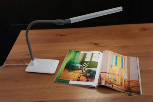 UnoPro Table Lamp with a colorful magazine